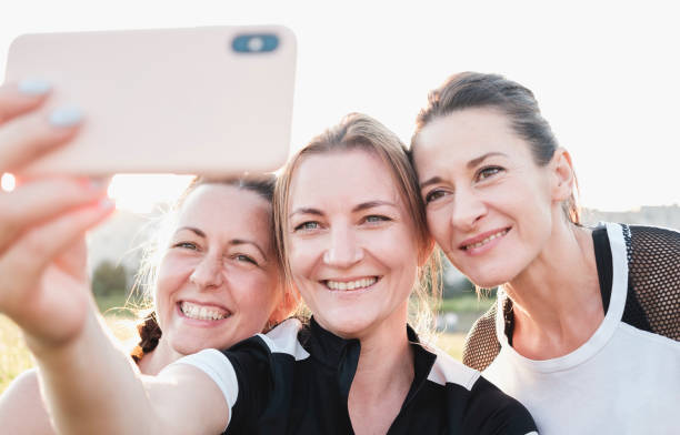 istock Three young woman friends taking a selfie 1256147642