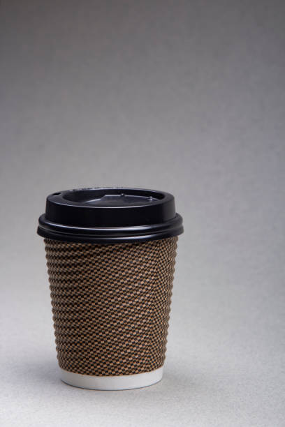 istock paper cup with coffee cappuccino on grey background Close up 1256150254