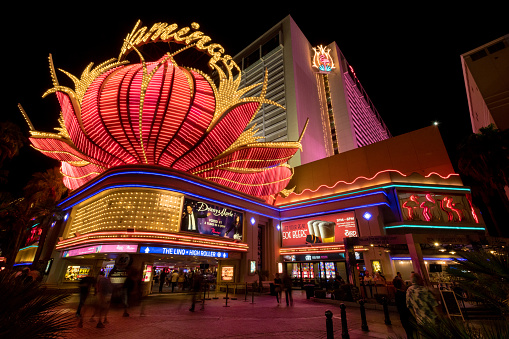 Las Vegas, USA - Sep 24, 2019:  The Iconic Flamingo Hotel and Casino illuminating Las Vegas Boulevard early in the evening. The hotel opened in 1945 under the development of Bugsy Siegel, its one of the oldest original casinos still on the strip.