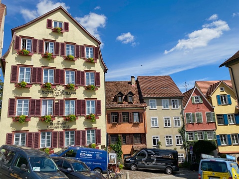 Tübingen, Germany - July, 13 - 2020: View of typical houses in an alley of the old town going up to the castle, the Burggasse.  Last parking place before reaching the castle Hohentübingen.