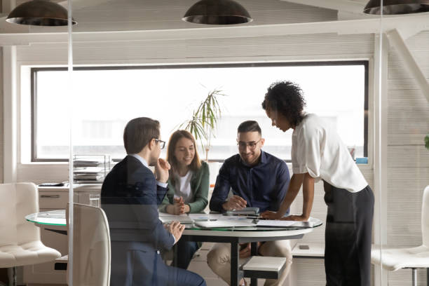 istock Smiling diverse colleagues cooperate at team meeting in boardroom 1256152590