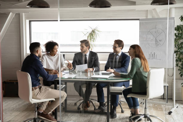 istock Multiethnic employees gather in boardroom brainstorming together 1256152599