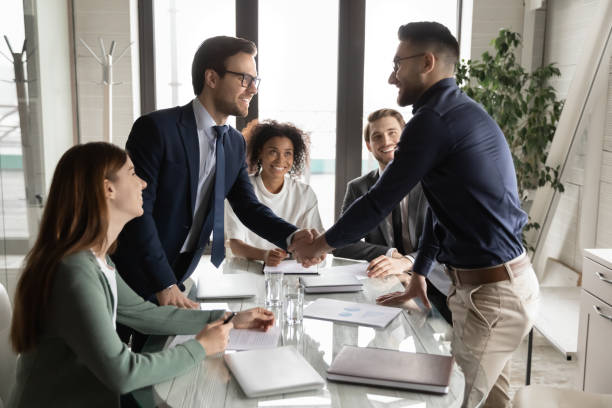 istock Smiling diverse businessmen handshake at meeting in office 1256152605