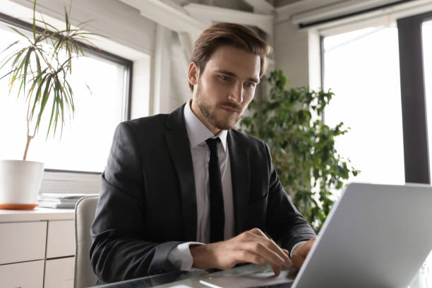 istock Focused Caucasian businessman work on computer in office 1256152689