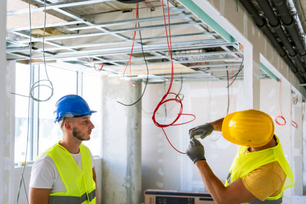 istock Electrician making wiring at new house 1256153303