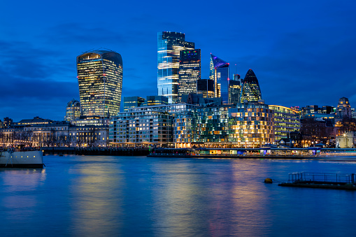 The City of London, financial district of the Metropole, just after sunset with illuminated buildings , United Kingdom