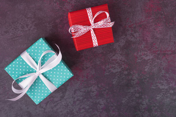 istock Red and blue gift boxes on dark stone background with copy space 1256156298