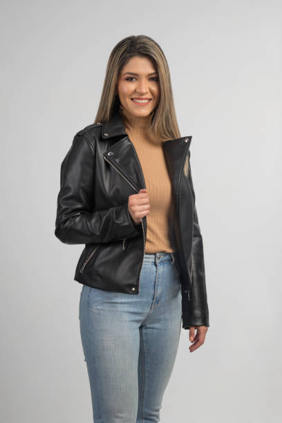 istock latin woman standing wearing a black leather jacket 1256157419