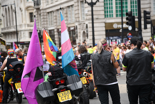 London, United Kingdom, July 6 2019: Happy lgbt people and supporters wearing colourful costumes with rainbow colors parading at the famous Pride Parade   on the 6th of July at London, UK.