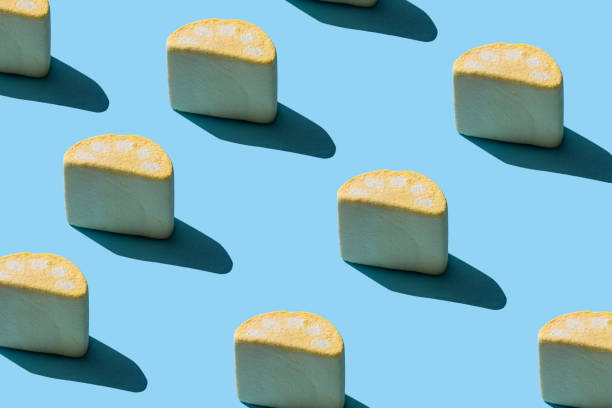 istock Collection of tasty marshmallows with hard shadows on a light blue background. 1256161026