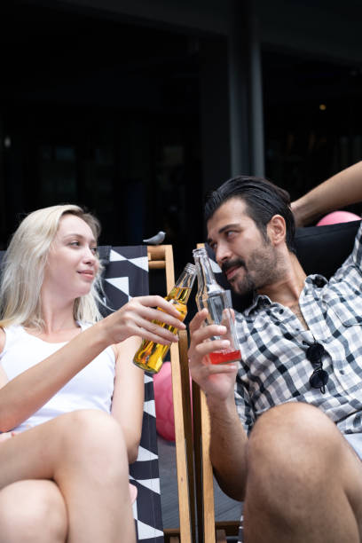 istock Couple relaxing and lying down on Beach chair 1256161095