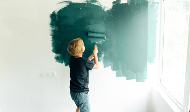 istock children paint the walls with a roller 1256162195