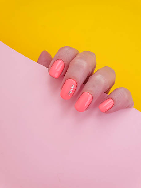istock female hand beautiful manicure on a colored background 1256162438