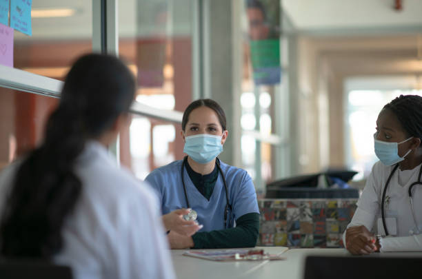 istock Doctors discussing with masks on 1256164125