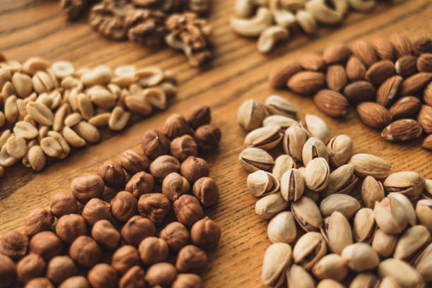 istock Different types of nuts, nut mix of almonds, hazelnuts, cashews, peanuts closeup 1256165357