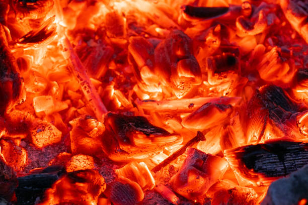 istock Smoldering charcoal in a bonfire, background texture 1256165378