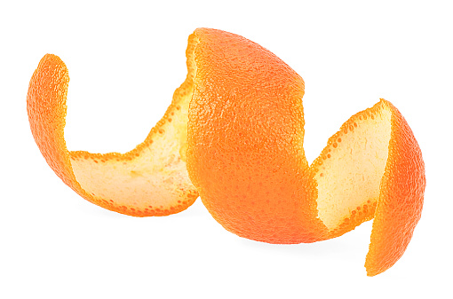 Fresh peel of orange fruit isolated on a white background. Orange zest spiral.