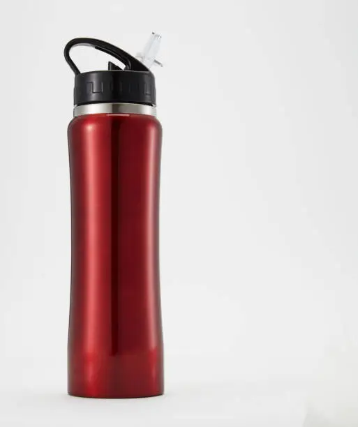 Full length red aluminium waterbottle. Isolated on white background.