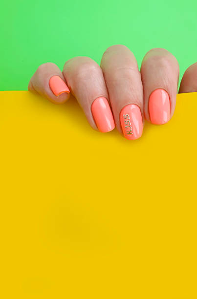 istock female hand beautiful manicure on a colored background 1256170698