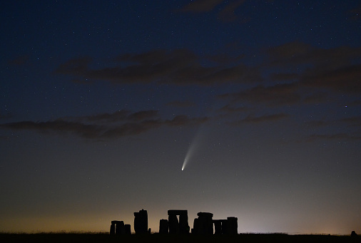 Comet Neowise streaks over the ancient stone circle and lone silhouette figure in Wiltshire, UK\nA very rare astronomical event  - a spectacular sight streaking across the skies over the UK and around the world.\n\nComet Neowise - officially called C/2020 F3 – first appeared towards the end of March.