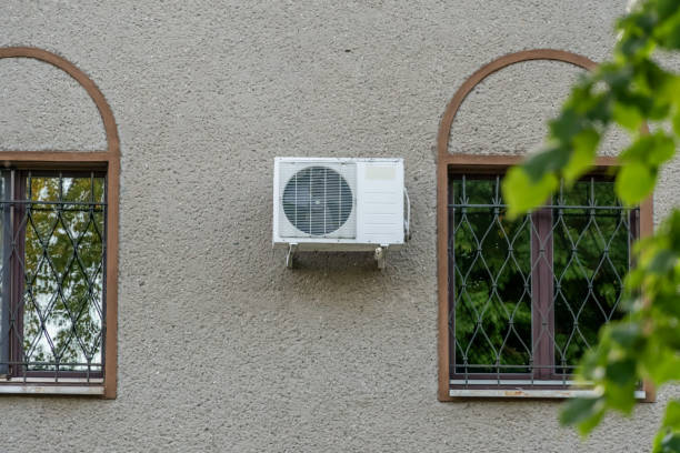klimaanlage außenanlage kompressor außerhalb des hauses an der wand in der nähe der fenster installiert - air conditioner window heat hot day stock-fotos und bilder