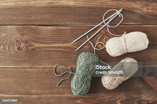 Balls Of Yarn On A Wooden Table Stock Photo - Download Image Now - Knitting Needle, Crochet, Knitting