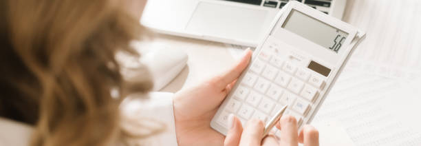 istock Close up businessman hand using calculator and writing make note with calculate about finance accounting.finance accounting concept 1256173794