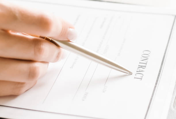 istock reads a contract and holds a metal pen 1256173808