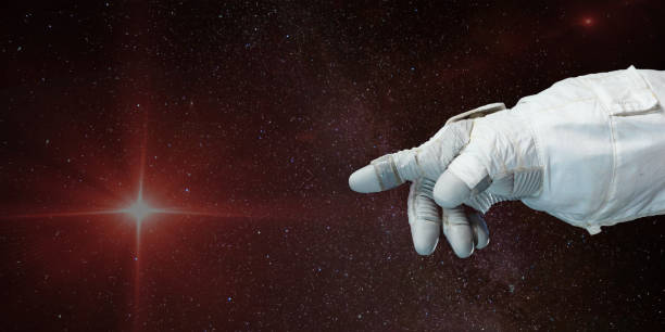astronaut hand pekar mot stjärnan med bakgrund av rymden. delar av denna bild möblerad av nasa. - astronaut bildbanksfoton och bilder