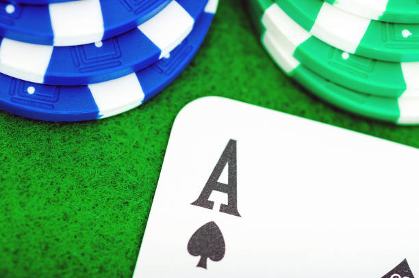 Close-up of the ACE of green and blue poker chips card on the green table. stock photo