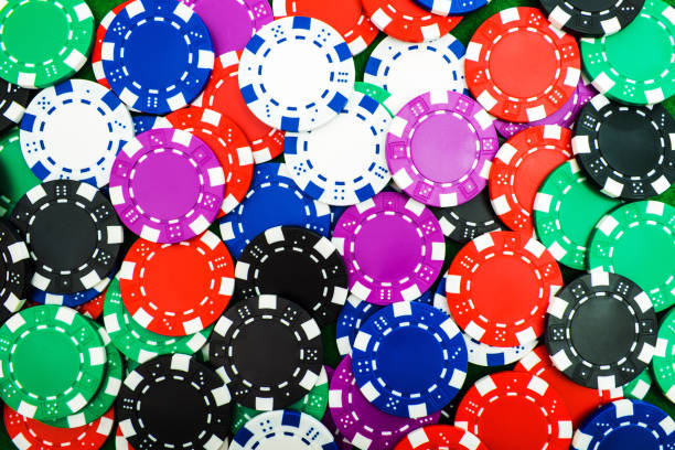 Background of round poker chips is a close-up of different denominations. stock photo