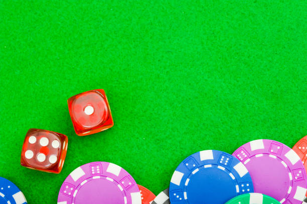 istock A close-up of poker chips and two red dice on a green cloth table with copy space. 1256178077