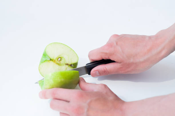 istock Female hands cutting apple with knife. 1256178119