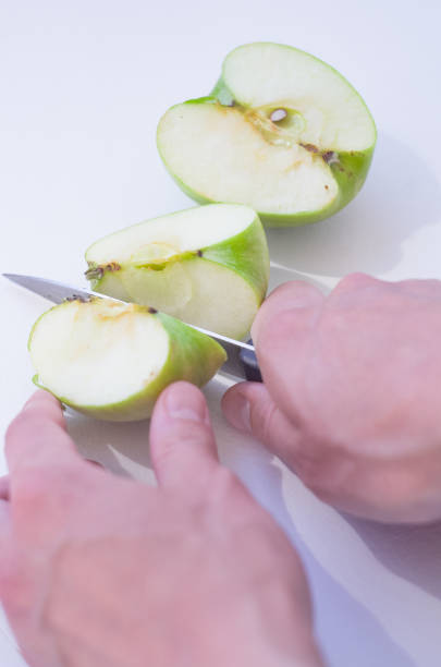 istock Female hands cutting apple with knife. 1256178151