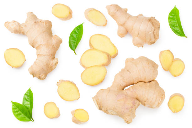 istock ginger roots with slices and green leaves isolated on white background. Top view 1256178393