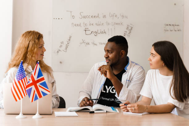 istock Online multiethnic attractive group of teachers study and laught, discuss something. Remote work in multinational group with laptop. Happy girls and black man speaking online by laptop 1256178502