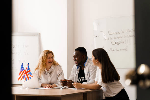 istock Online multiethnic attractive group of teachers study and laught, discuss something. Remote work in multinational group with laptop. Happy girls and black man speaking online by laptop 1256178566