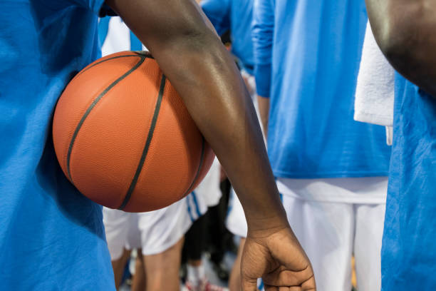 istock Basketball player holding ball 1256180222