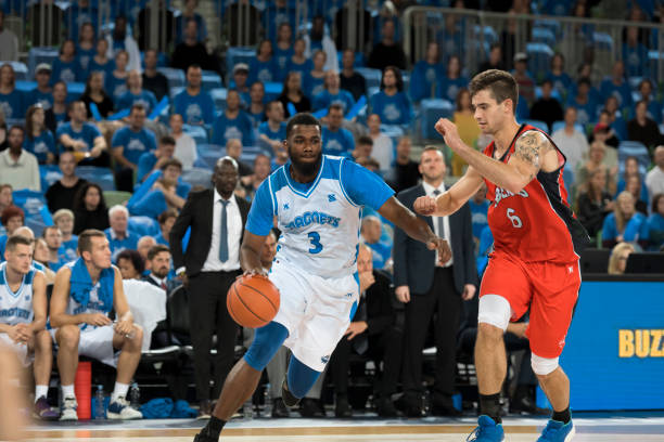 istock Basketball player dribbling ball 1256180241