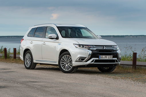 Usedom, Germany - 1st July, 2020: Plug-in hybrid car Mitsubishi Outlander PHEV on a road. This model is the most popular PHEV vehicle in Europe.
