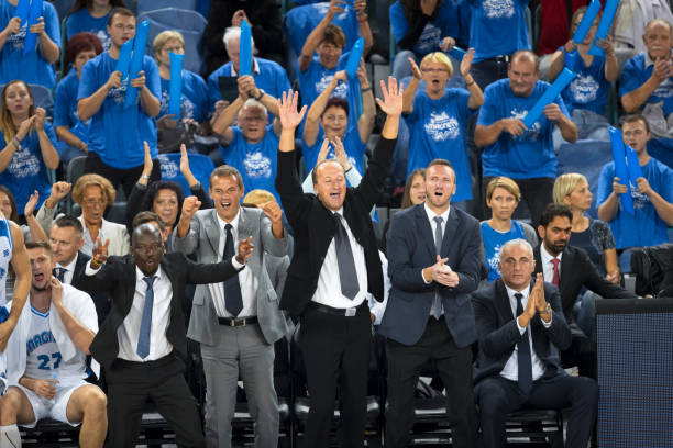 istock Spectators and coach cheering in stadium 1256181515
