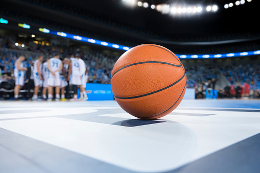 TV Broadcast Style Footage Of Basketball Championship: Yellow Team Passing the Ball Between Teammates, Forward Player Aiming to Score a Two-Point Goal From Distance. Sport Channel Concept.