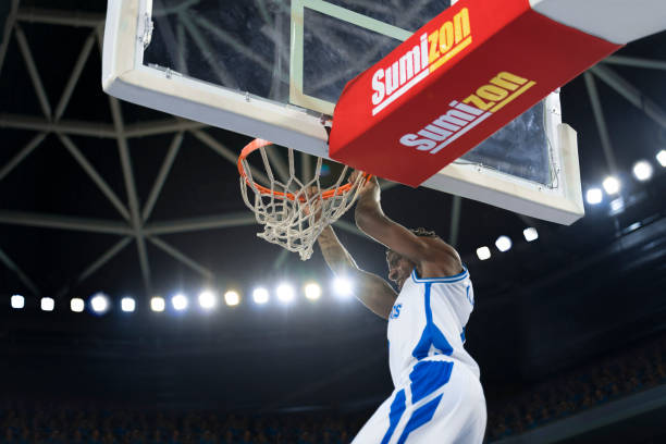 istock Basketball player hanging on hoop 1256182538