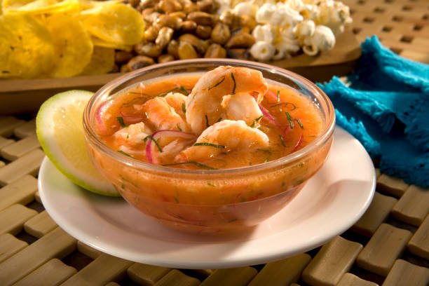 Ecuadorian shrimp ceviche Ecuadorian shrimp ceviche is a very popular dish in Ecuador. It's a cold soup with shrimp, with fresh tomato, lime and a bit of orange juice. Served with fried plantains, popcorn and toasted corn. seviche photos stock pictures, royalty-free photos & images