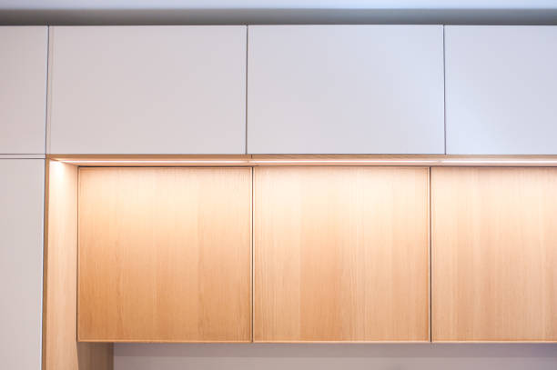 istock Kitchen cabinets, shelves with lighting, doors oak veneer and white. Close-up. 1256186721