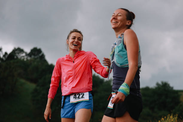istock Two female runners celebrate in the nature 1256187842