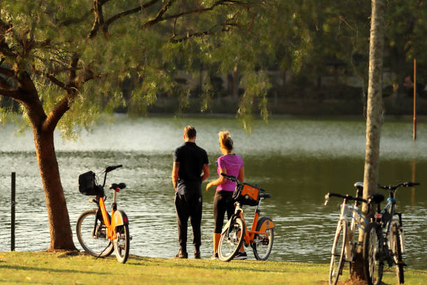 a couple in a lake Sao Paulo, Brazil August 18th, 2018. A couple are in front of a big lake located into the Ibirapuera Park, on a sunny afternoon. ibirapuera park stock pictures, royalty-free photos & images