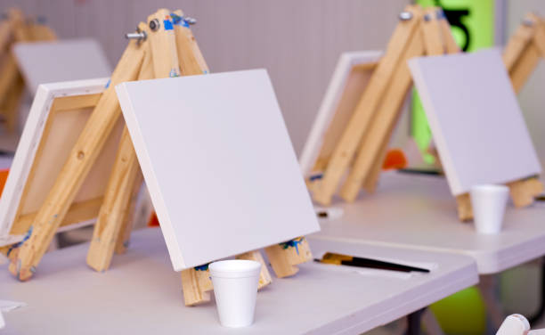 istock several easels prepared for a lesson with a set of brushes 1256190311