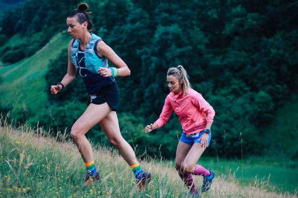 istock Two female runners racing in the nature 1256192401