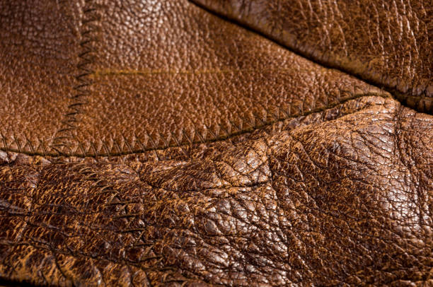 istock Old vintage genuine soft brown leather texture background, top layer with pores and scratches, macro, close-up 1256192510